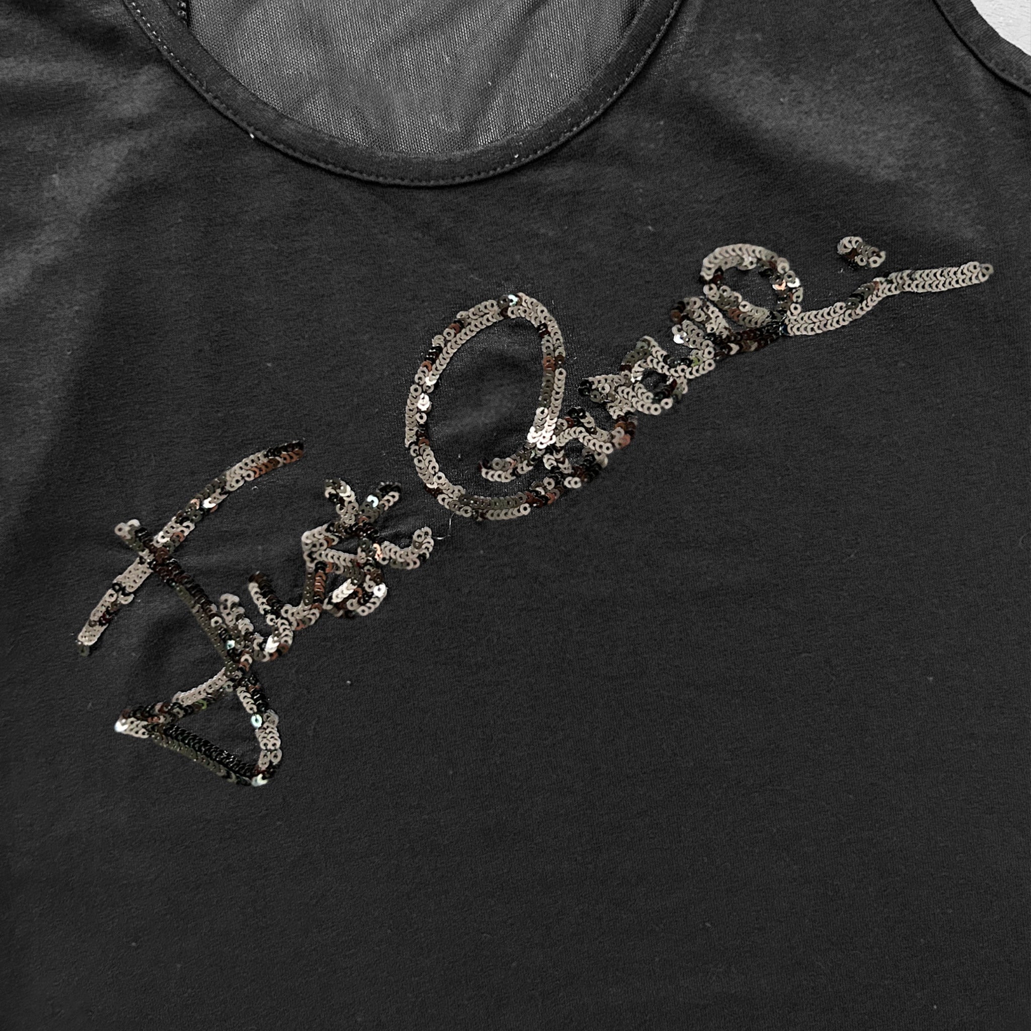 a close-up view of a black fabric with a decorative pattern of sequins or beads.