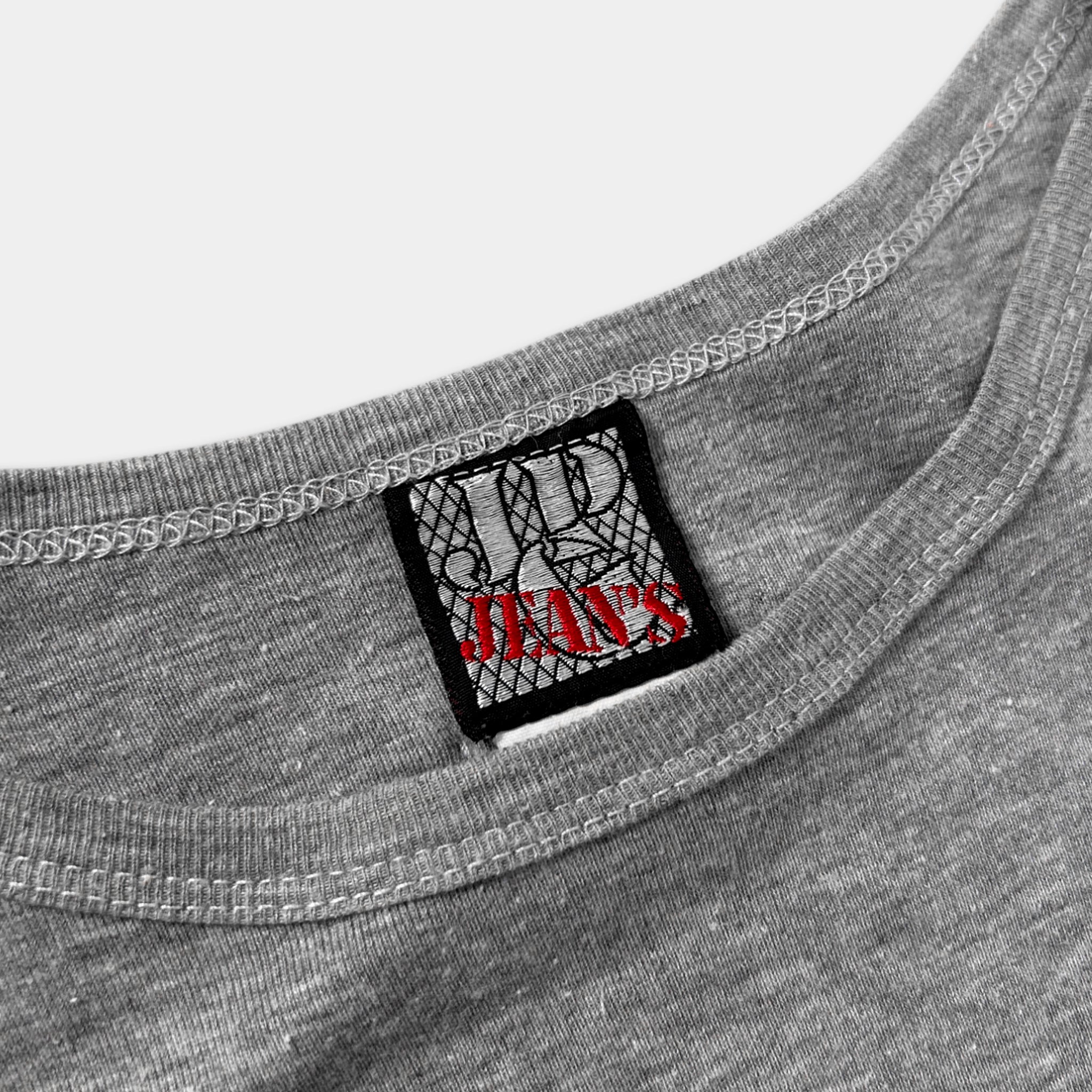 A gray t-shirt with a small black and red label on the collar.