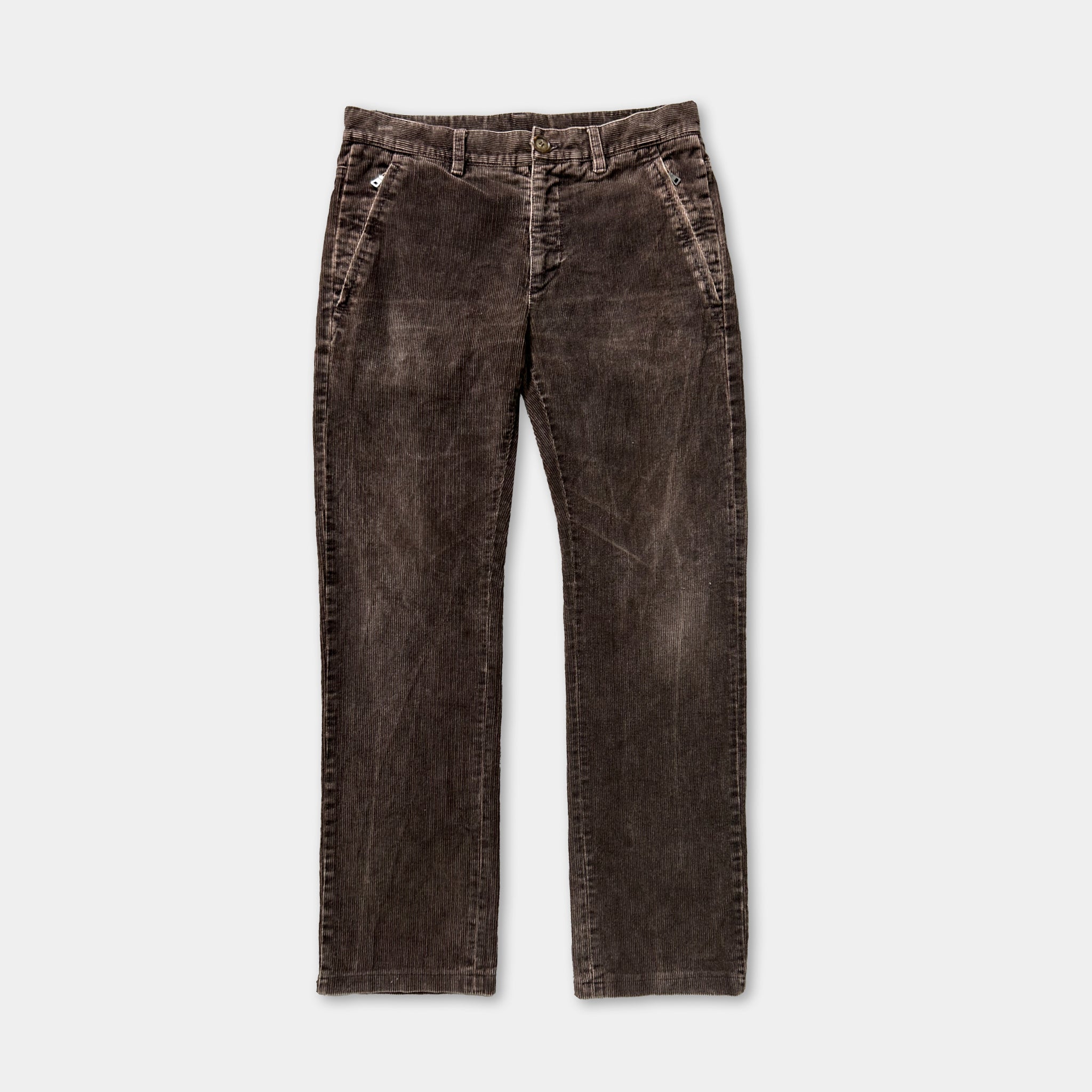 A pair of dark brown, distressed jeans with a button waistband and zipper pockets.
