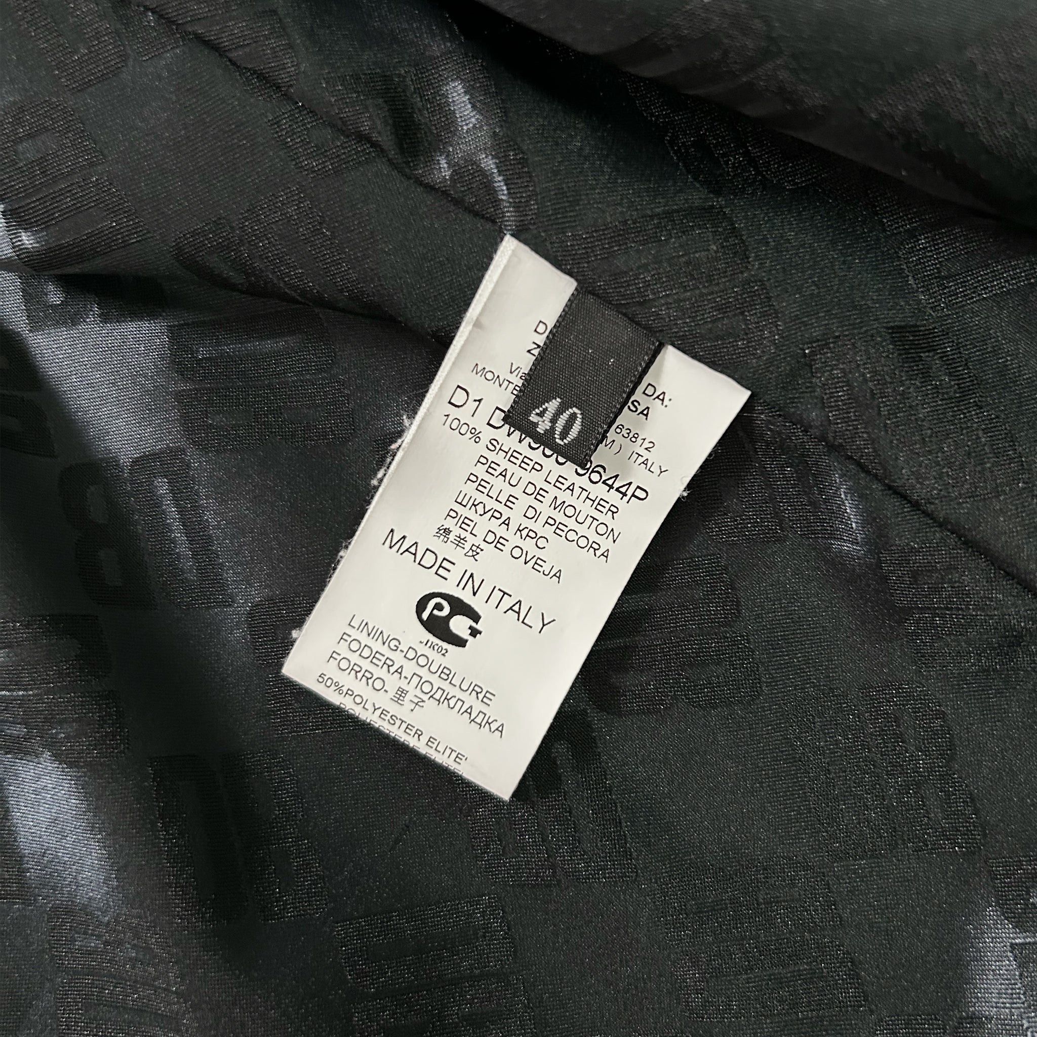 a close-up view of a black fabric with a label attached to it, which appears to be a garment or textile.