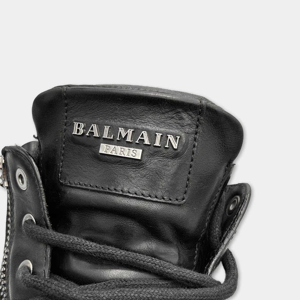 A close-up view of a black leather shoe with the Balmain logo and the text "PARIS" printed on it.