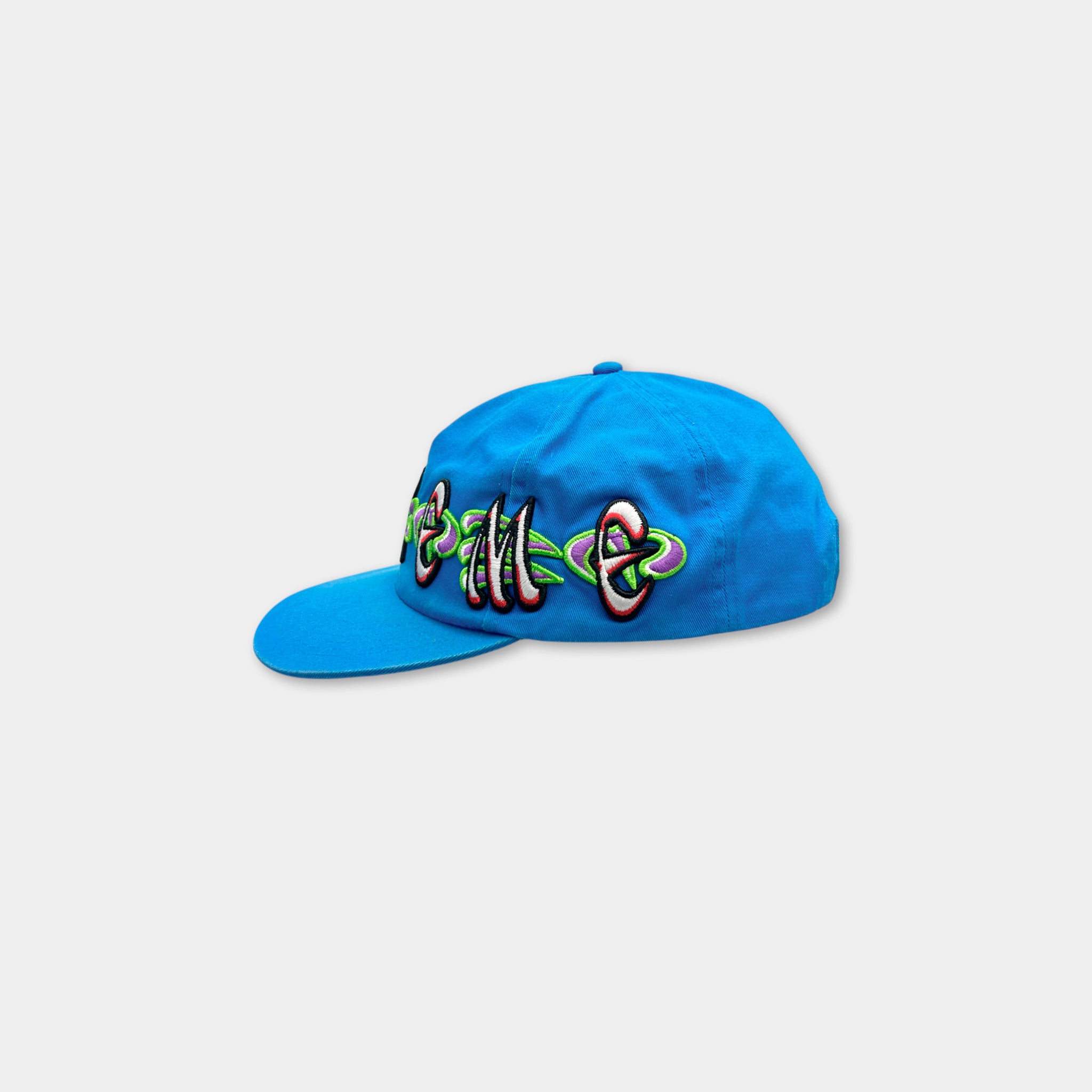 A blue baseball cap with colorful embroidered text on it.