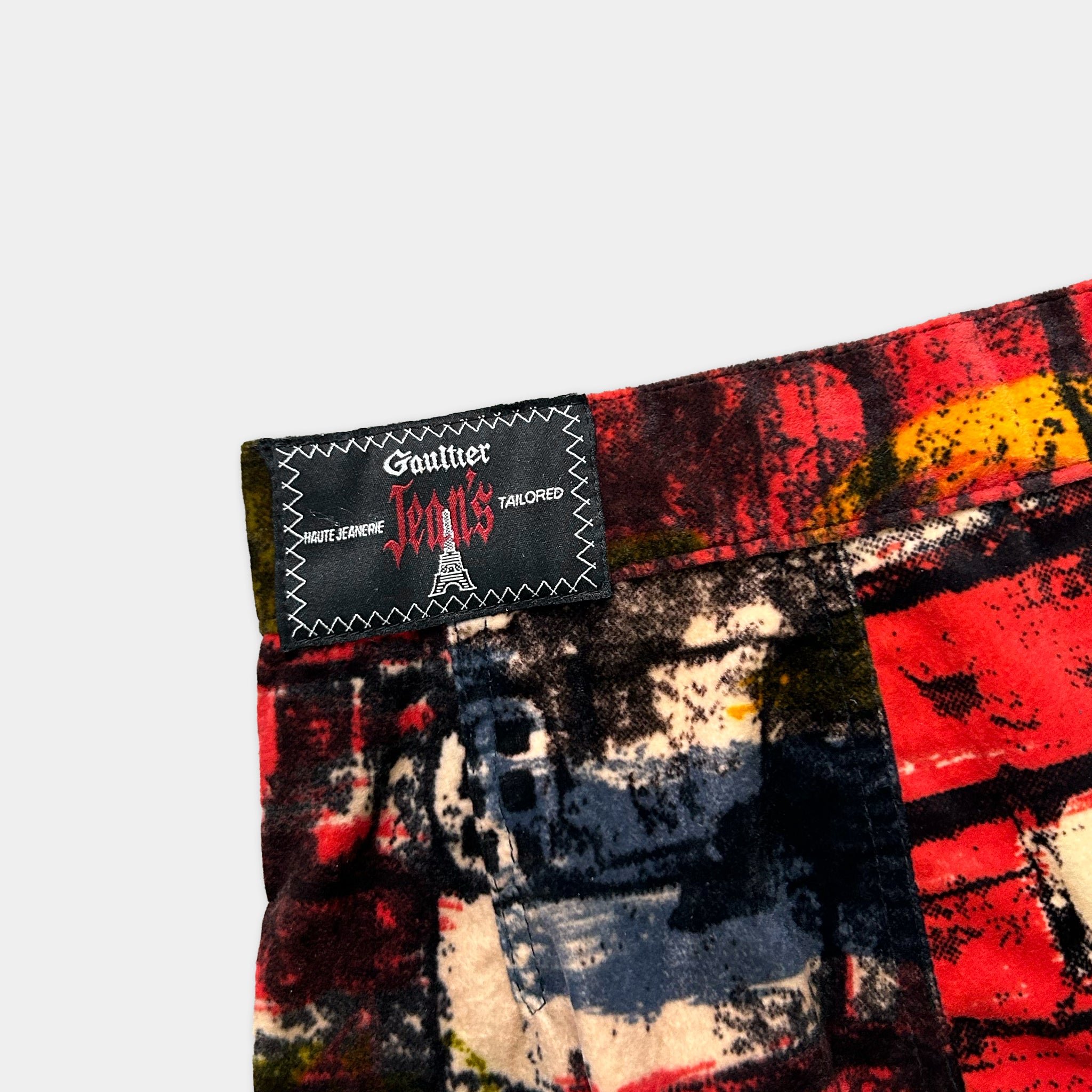 a pair of colorful printed pants with a label attached to the waistband.