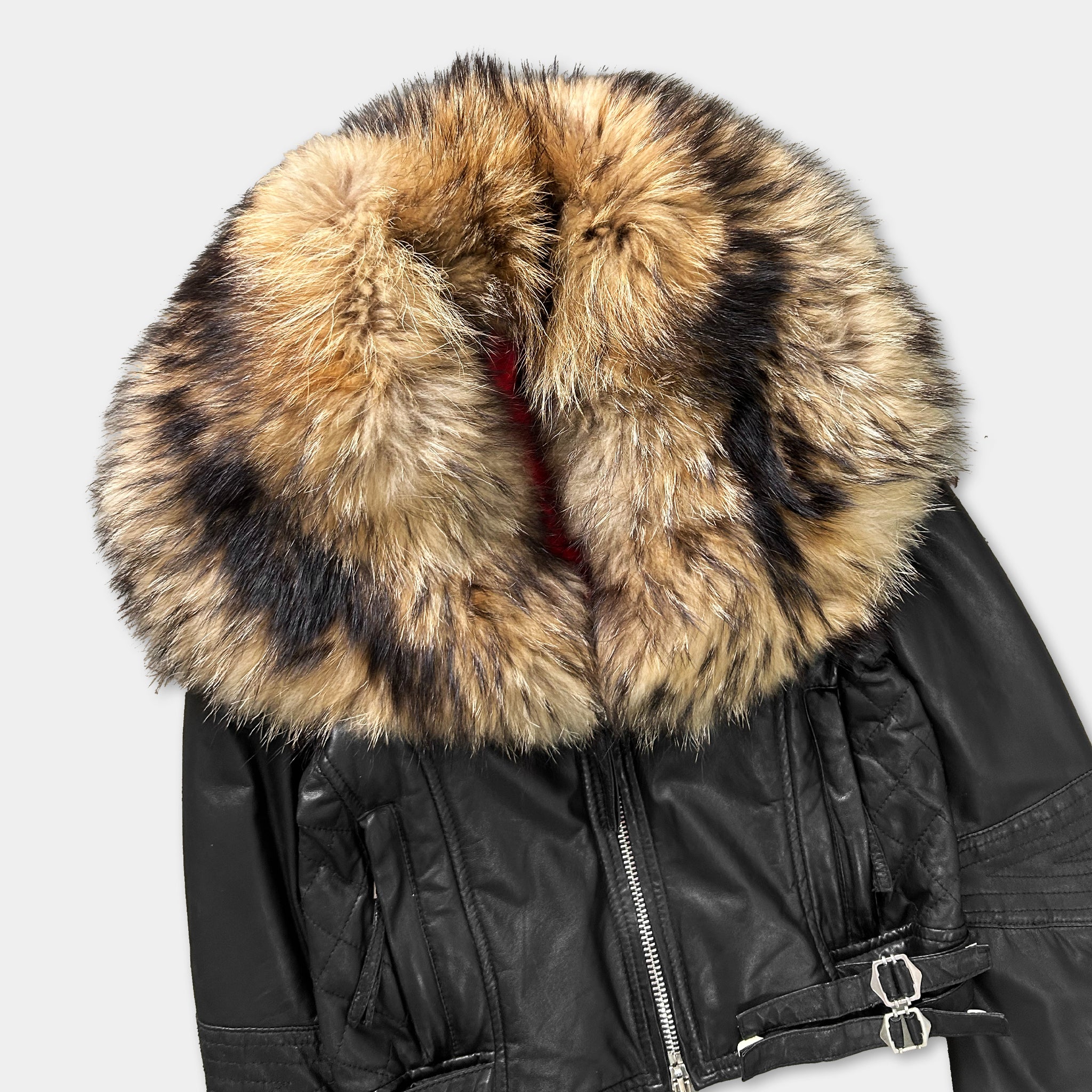 A black leather jacket with a fur collar and zipper.