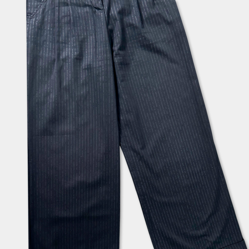 A pair of black pinstriped pants against a white background.