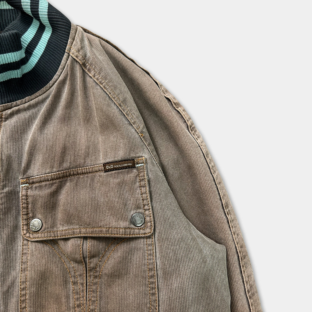 a close-up view of a brown jacket with a black and green striped collar.