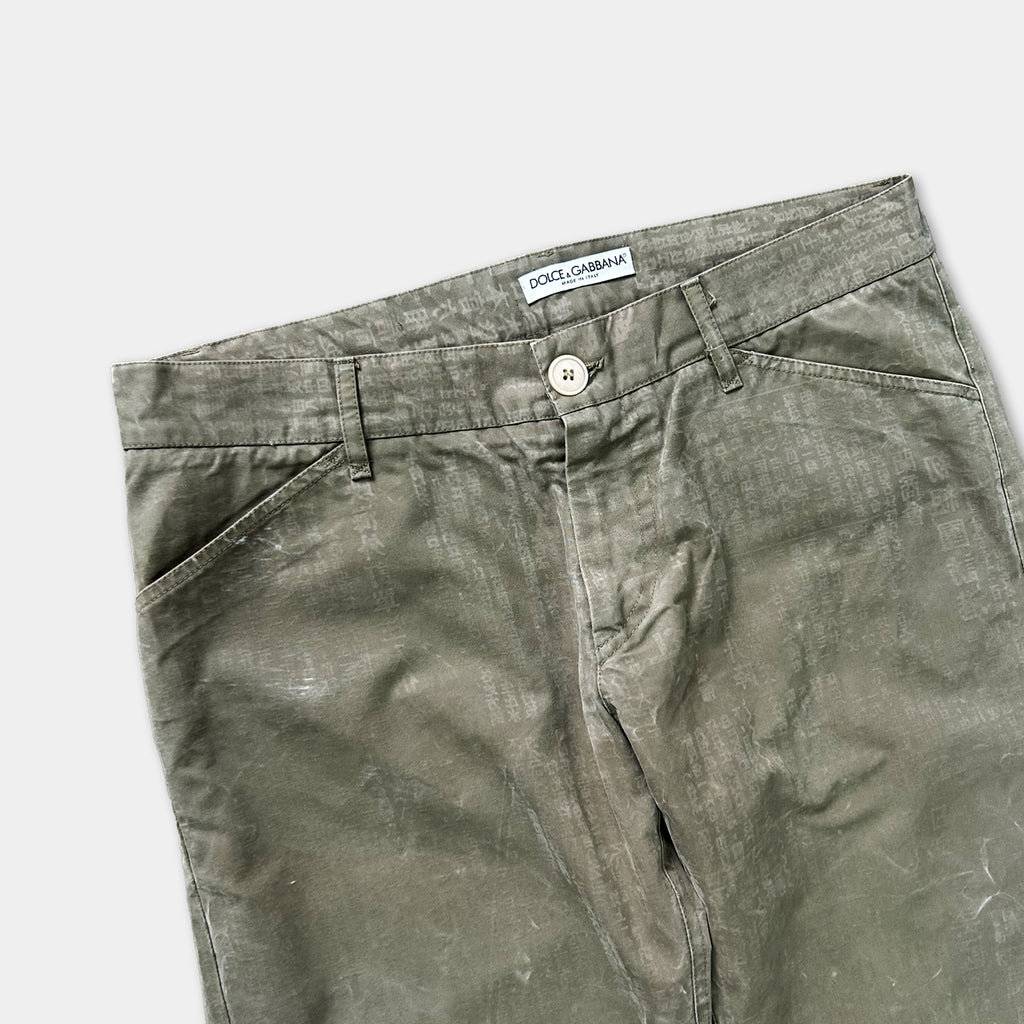 A pair of olive green cargo pants with a label on the waistband.