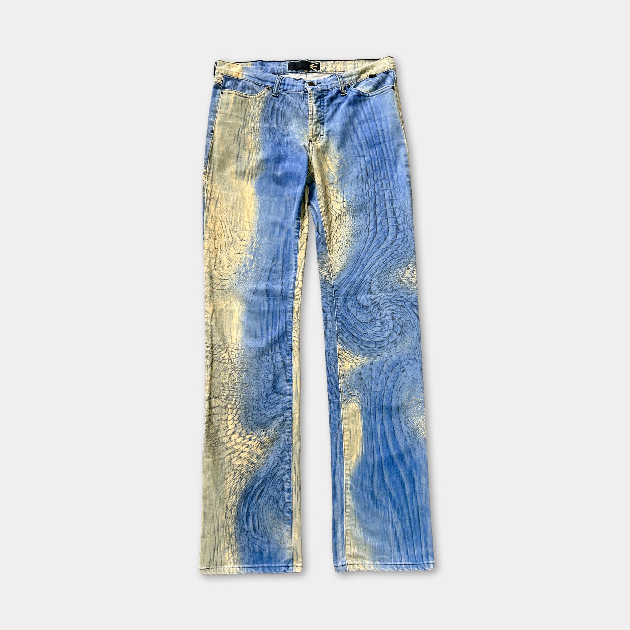A pair of blue jeans with a unique, swirling pattern in shades of blue and yellow.
