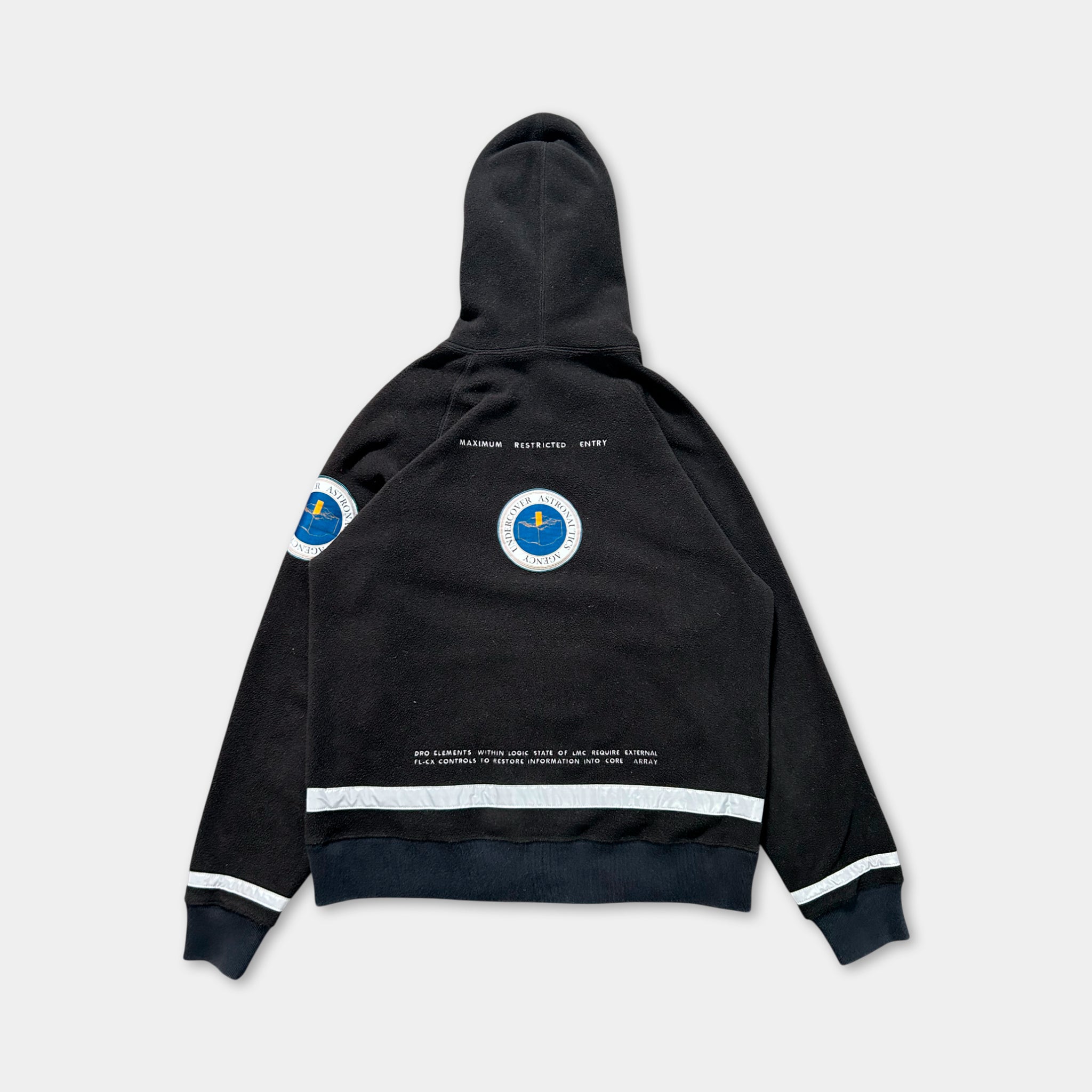 a black hooded sweatshirt with a circular logo on the back.