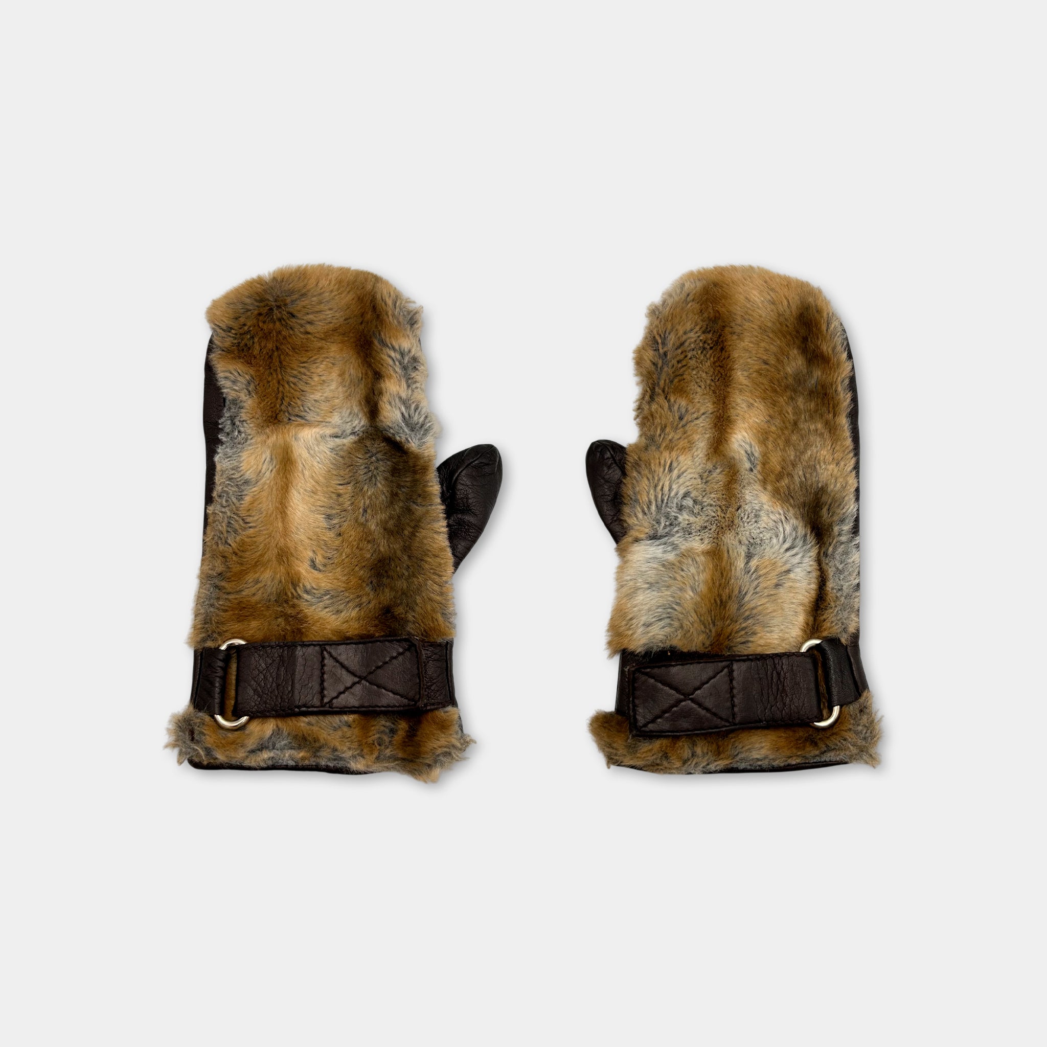 A pair of brown fur-lined mittens with a black leather strap.