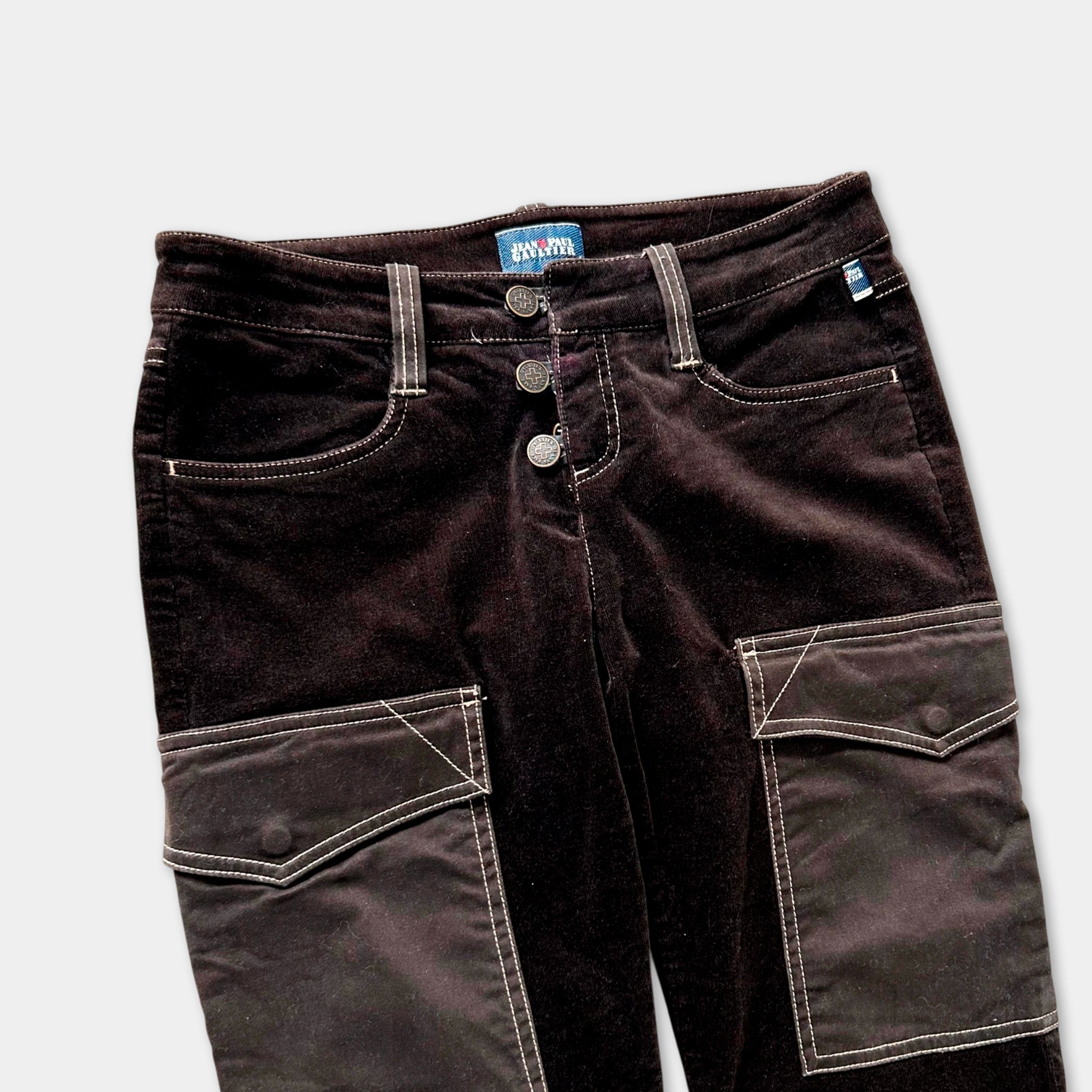 A pair of dark brown velvet pants with a button closure and two pockets.