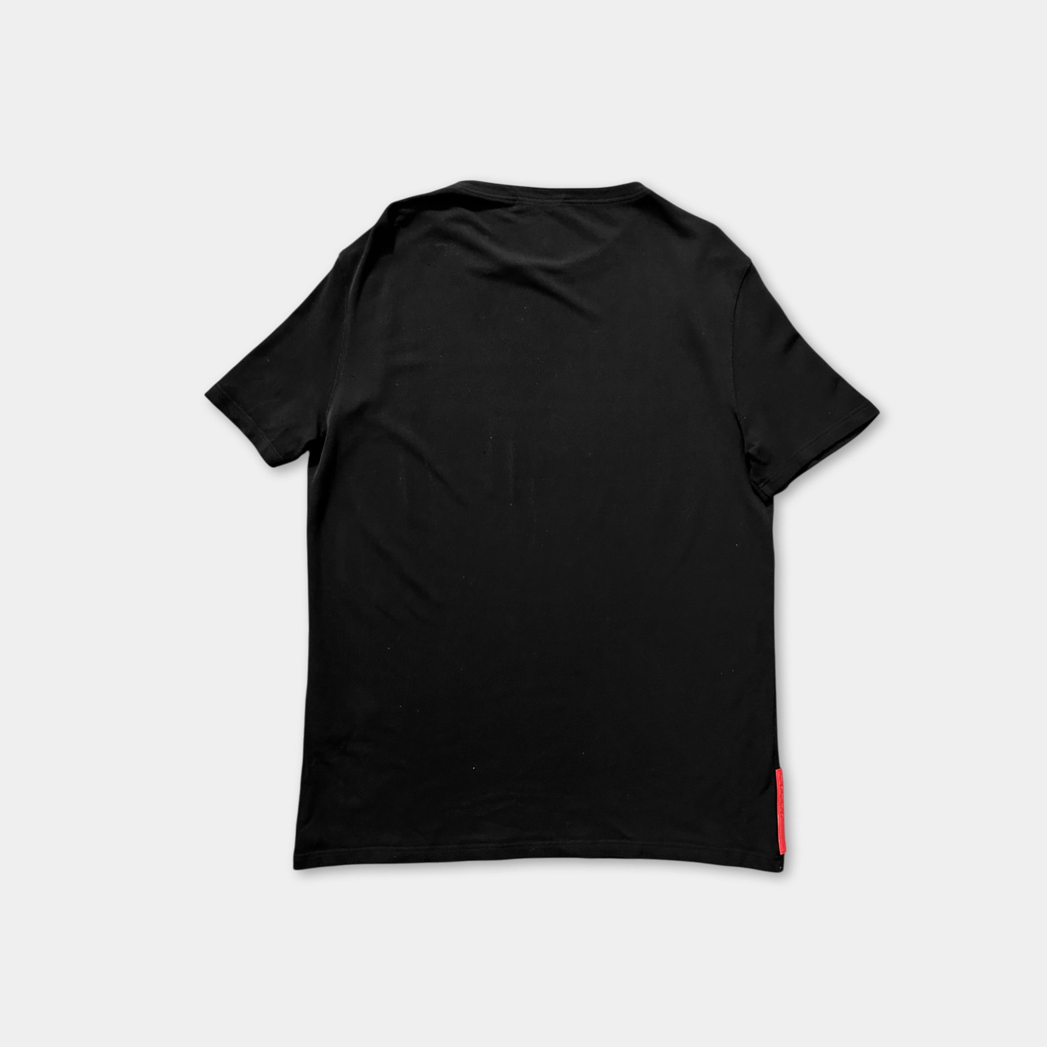 The image is a black t-shirt with a red tag on the right side.