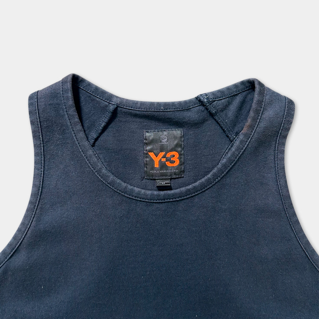 A dark blue tank top with a black label on the collar.