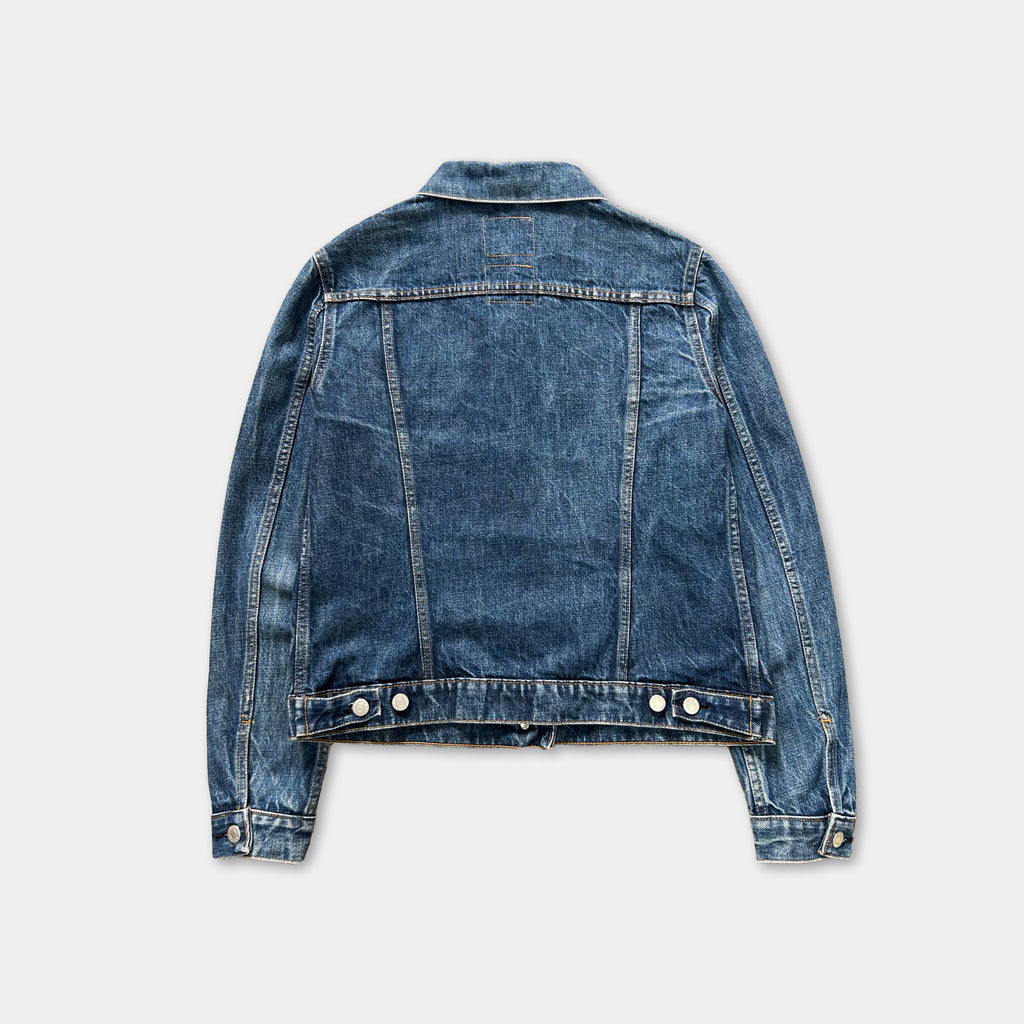 A denim jacket with a classic button-down front and long sleeves, displayed against a plain background.