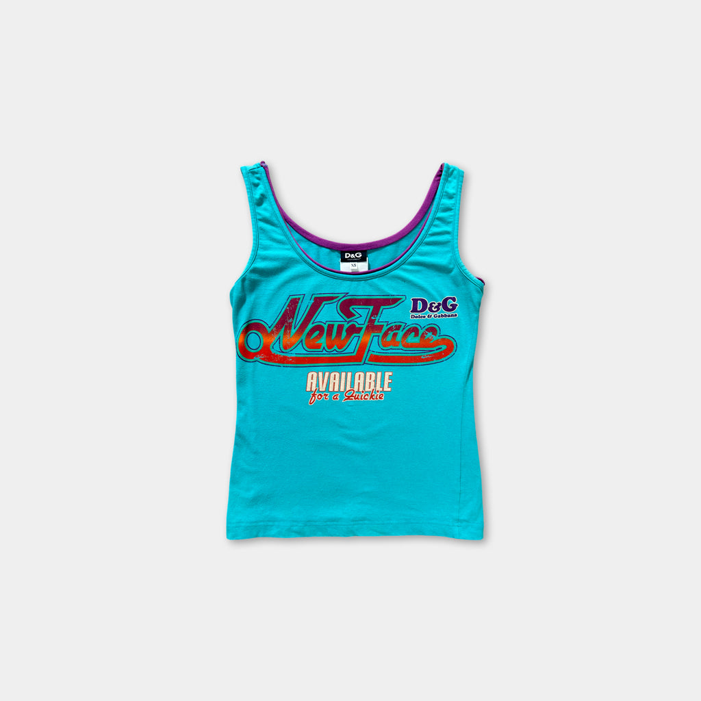 A turquoise tank top with a graphic design on it.