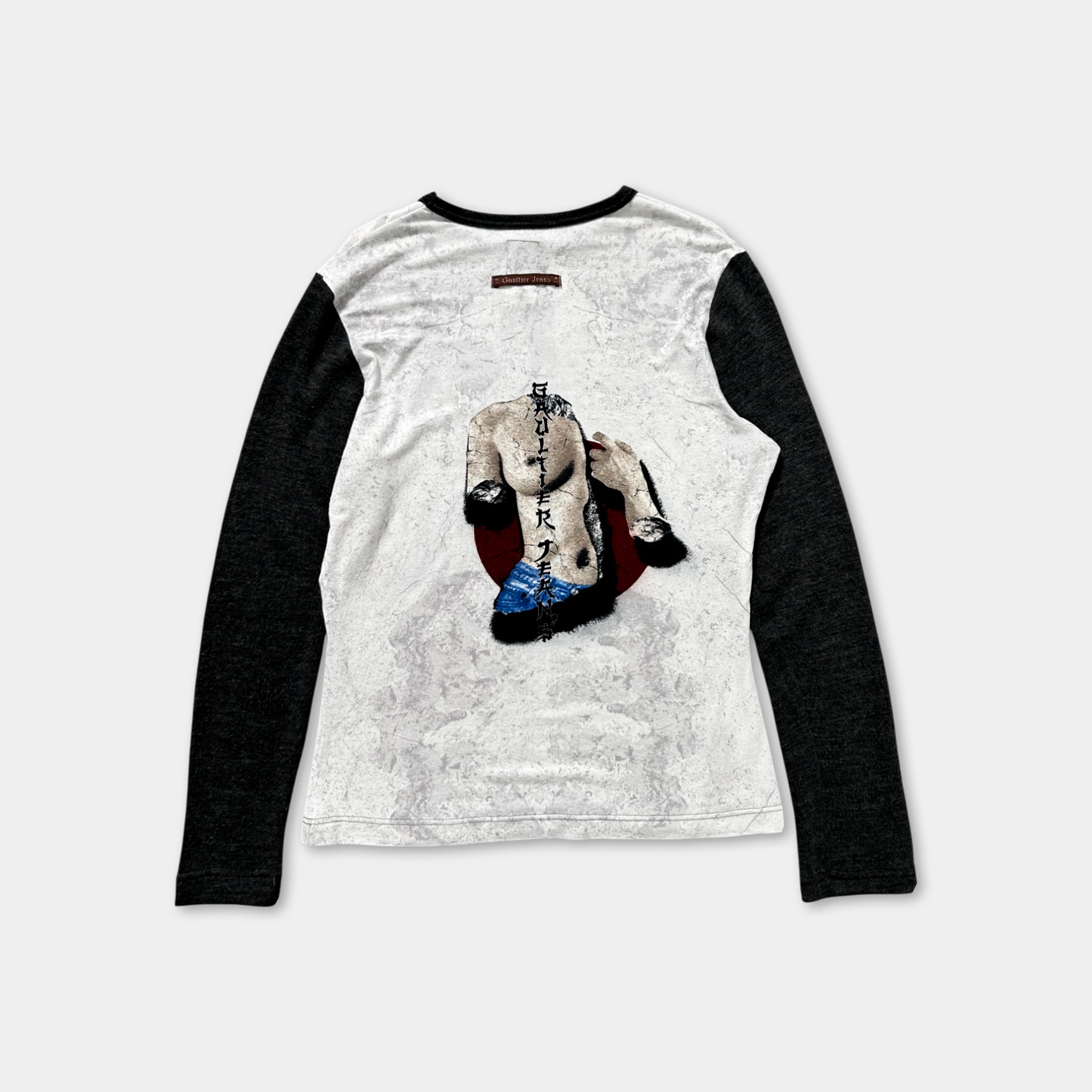 a white long-sleeved shirt with a graphic design on the back.