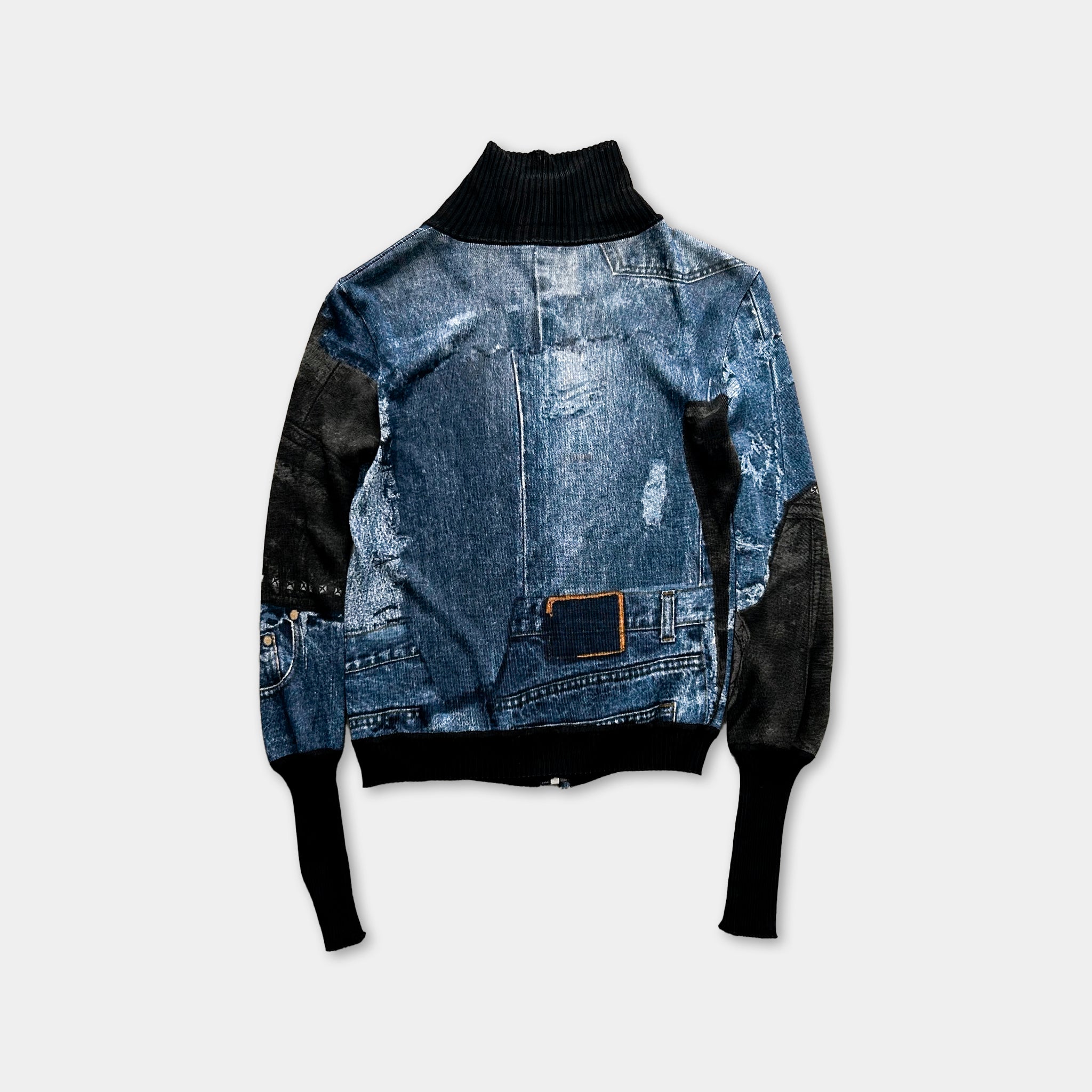 A denim jacket with a black turtleneck and black sleeves, featuring a distressed denim texture and patches of black fabric.