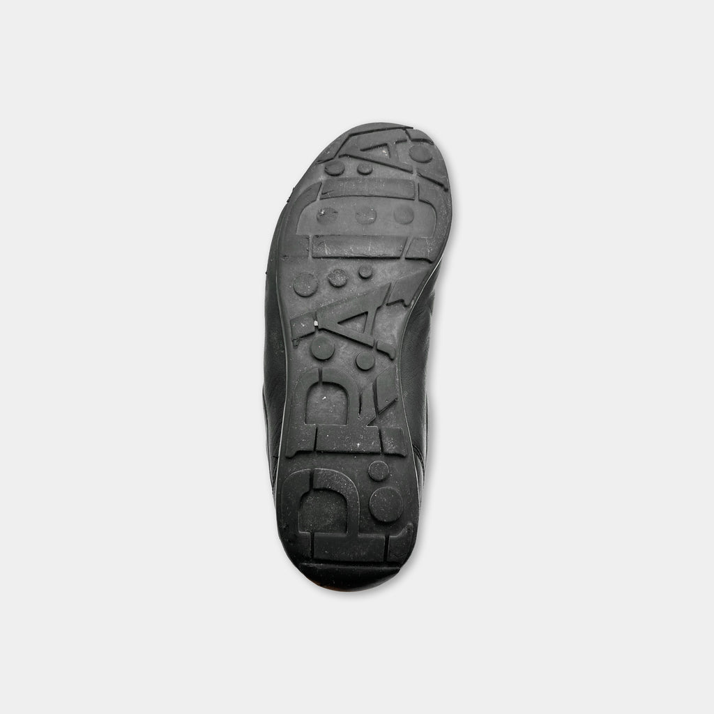 the sole of a black shoe with a unique tread pattern.