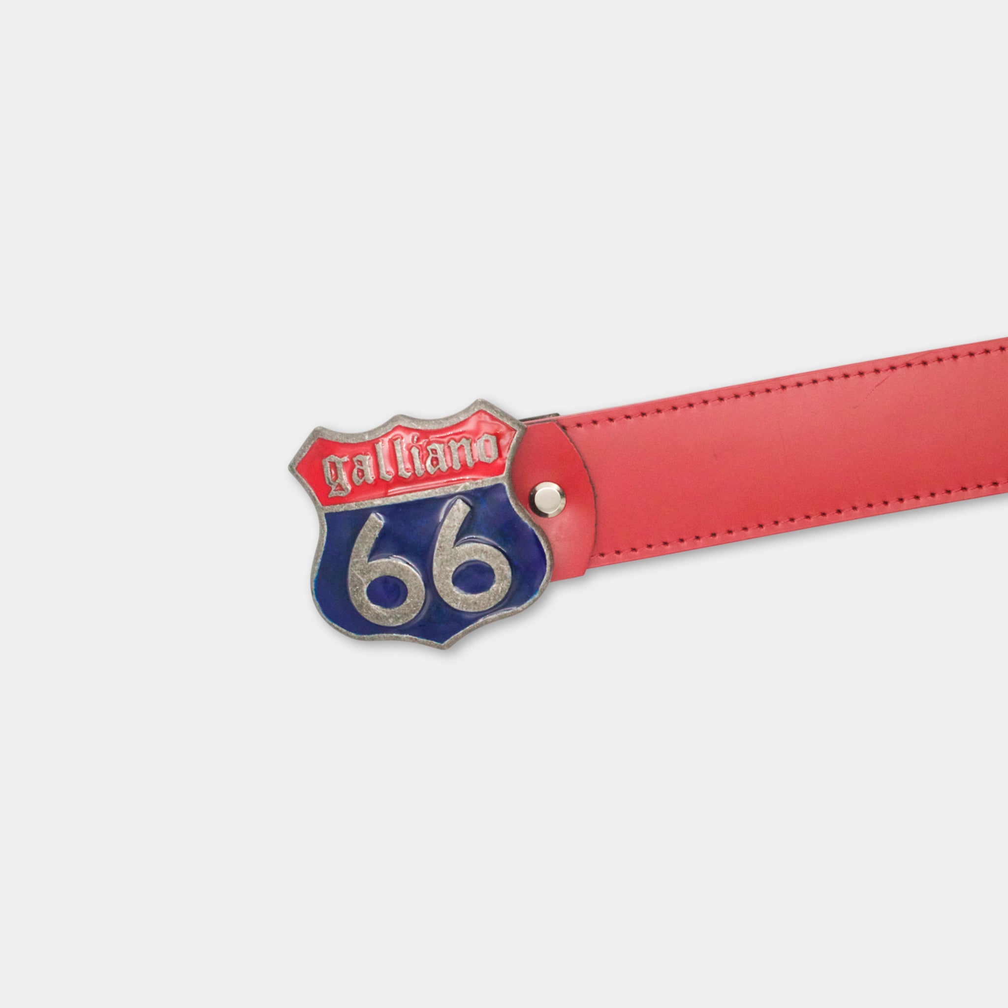 A red leather belt with a silver and blue metal buckle that displays the number 66.