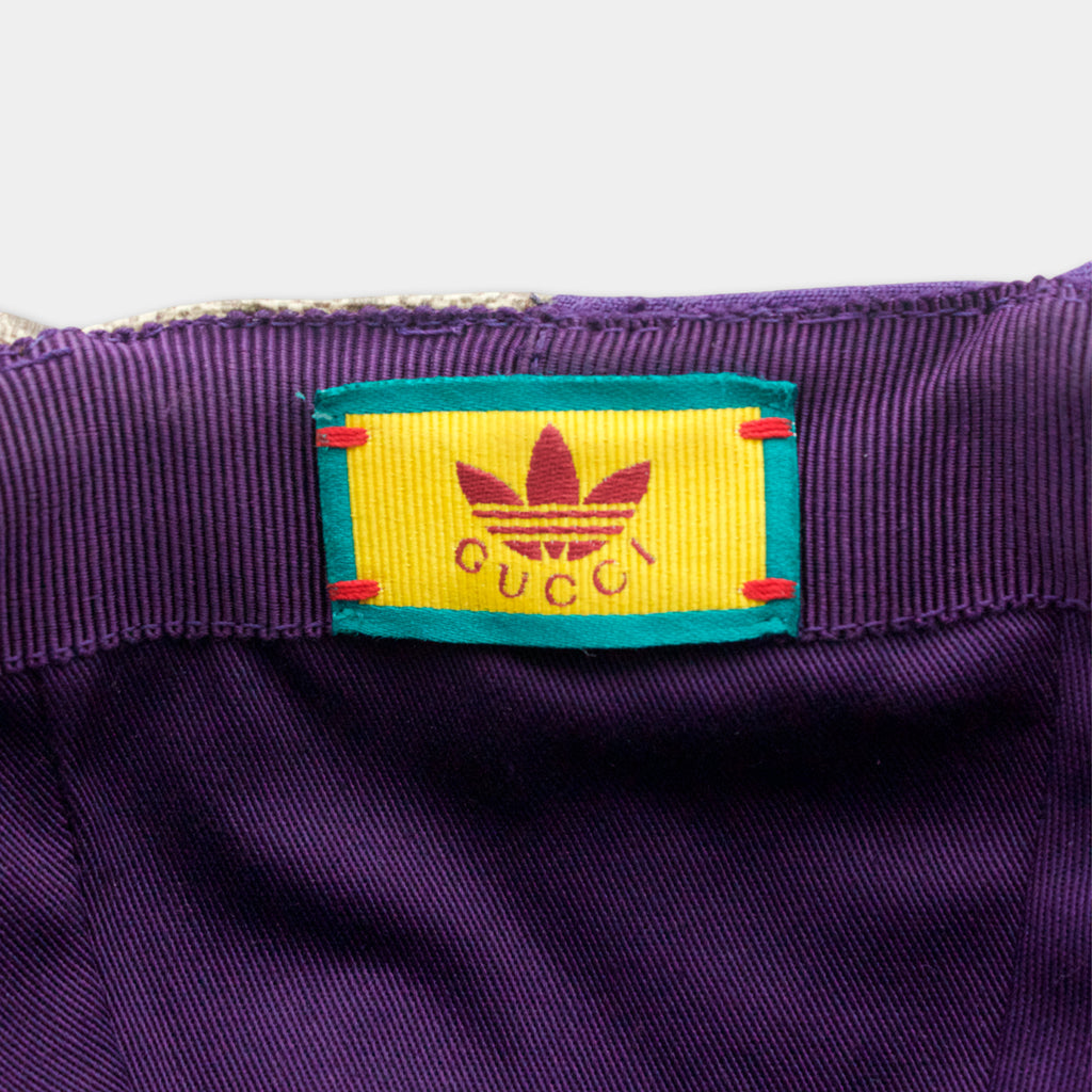A purple fabric with a yellow and green label featuring the Gucci logo.