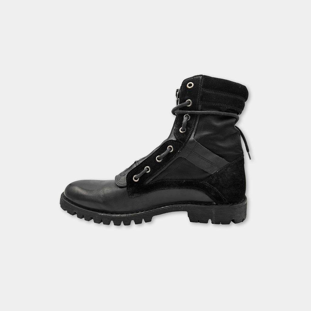 A black leather boot with a lace-up design and a rugged sole.