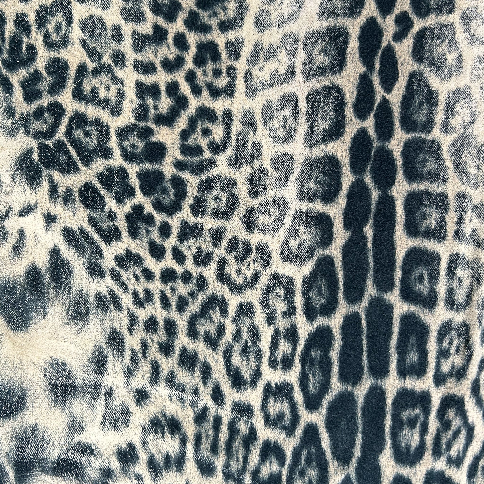 a close-up view of a textured surface with a repeating pattern of black and white spots, resembling the skin texture of a leopard or a similar animal.