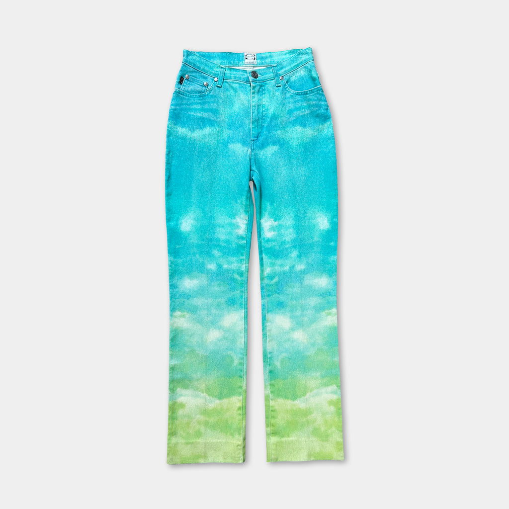A pair of blue jeans with a tie-dye pattern that resembles a cloudy sky.