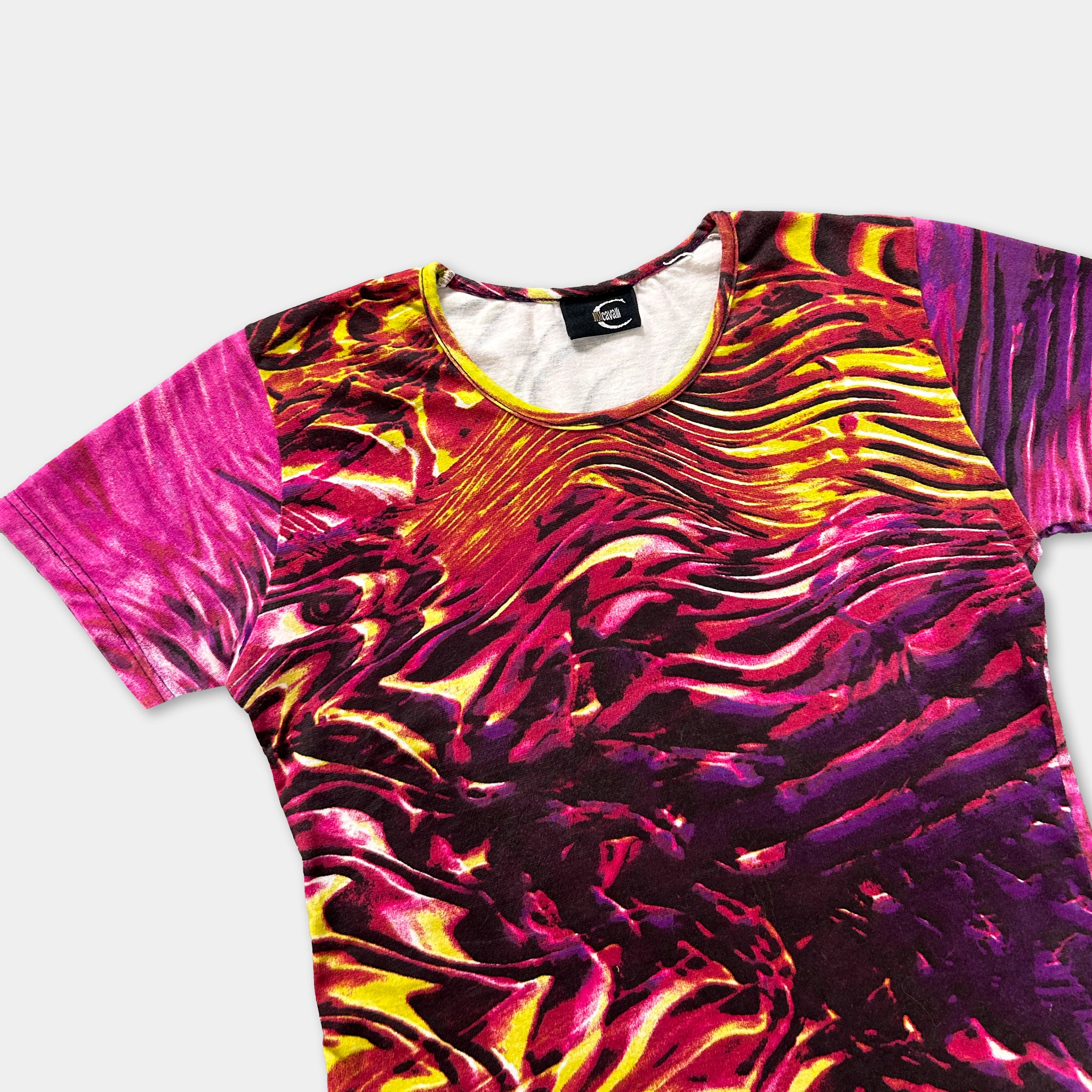 a colorful, abstract patterned shirt with a mix of pink, yellow, and purple hues.