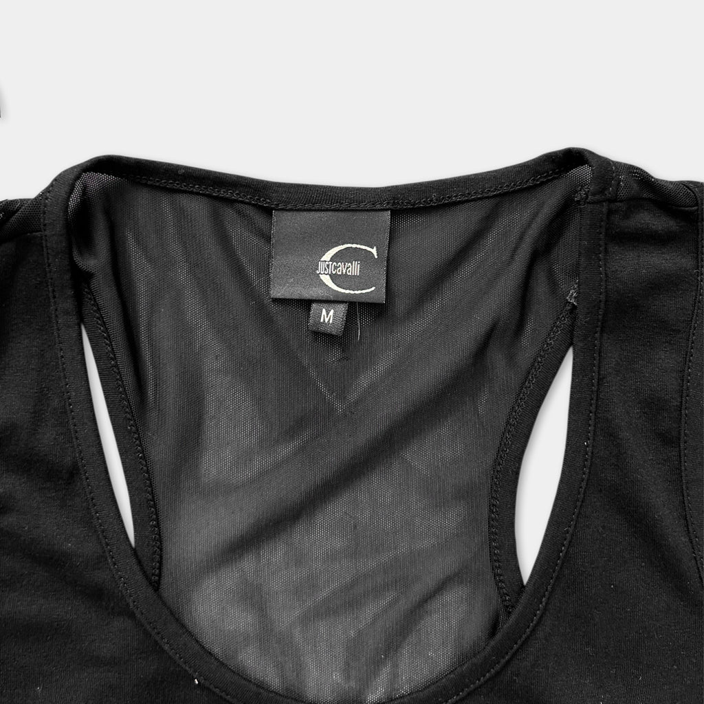 a close-up view of a black tank top, with a label visible on the collar.