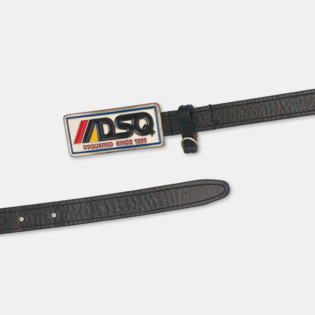 A black leather belt with a metal buckle and a metal plate attached to it.