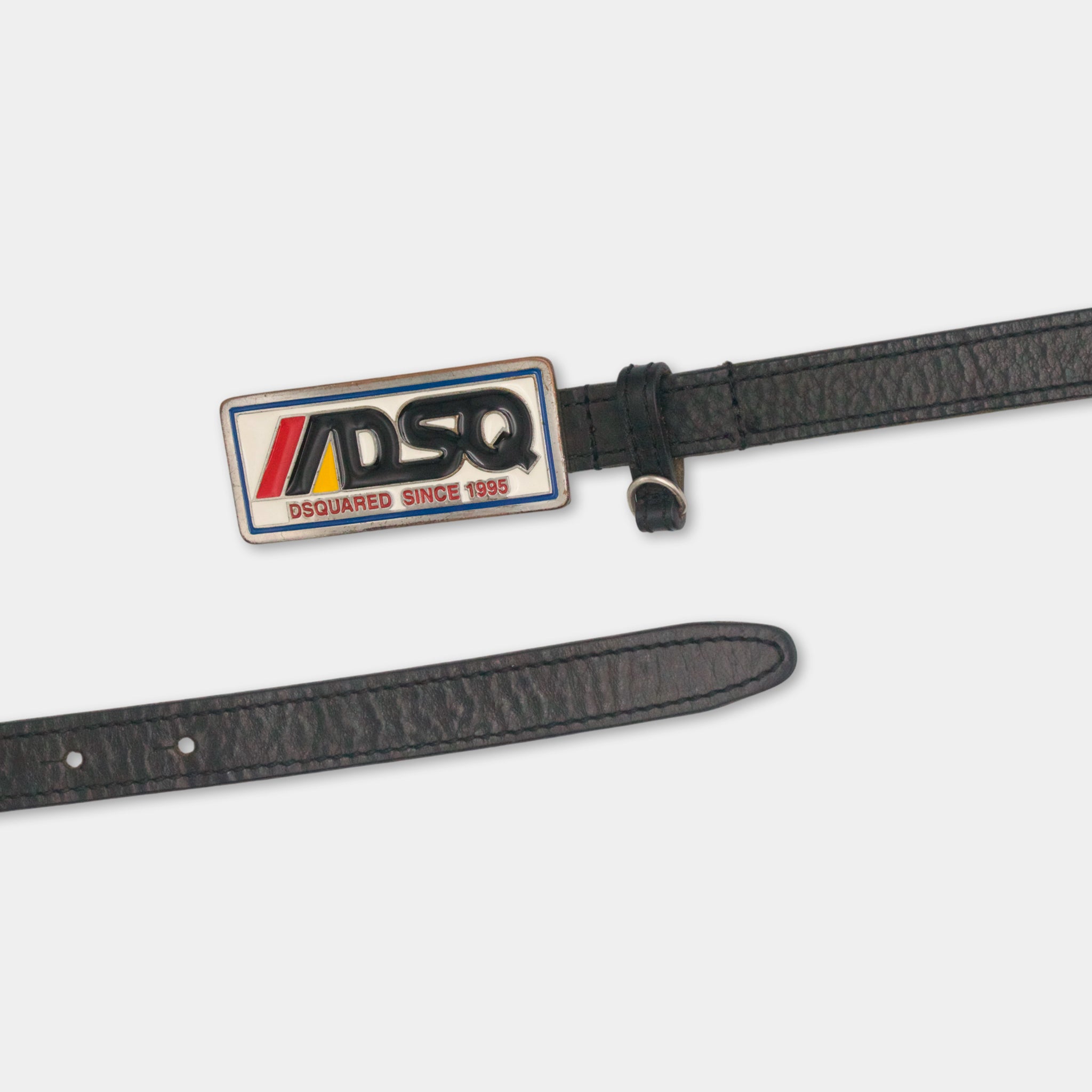A black leather belt with a metal buckle and a metal plate attached to it.
