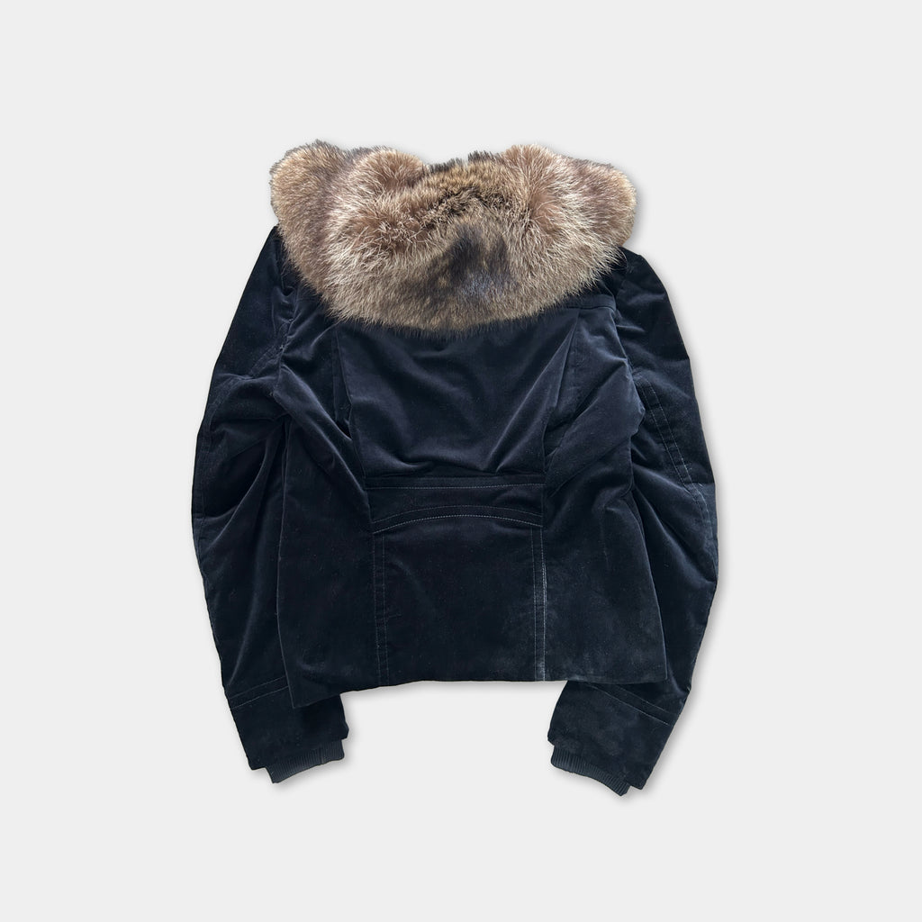 A black velvet jacket with a fur collar is shown against a white background.
