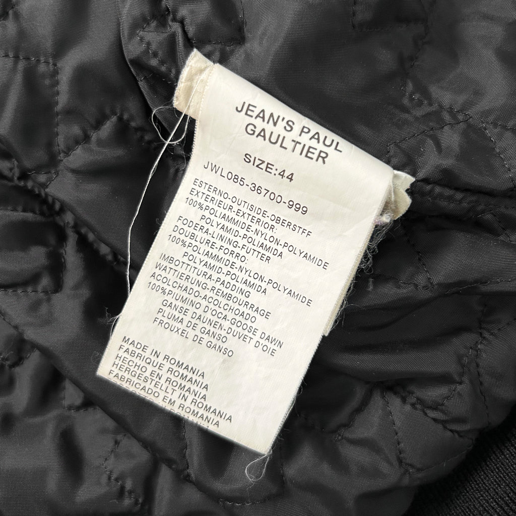 a close-up view of a label on a jacket, providing information about the jacket's size and material.