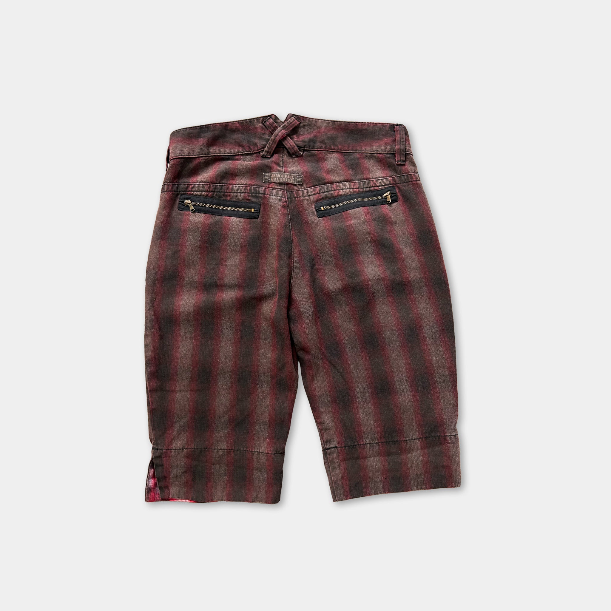 a pair of red and black striped shorts with a zipper detail on the back.