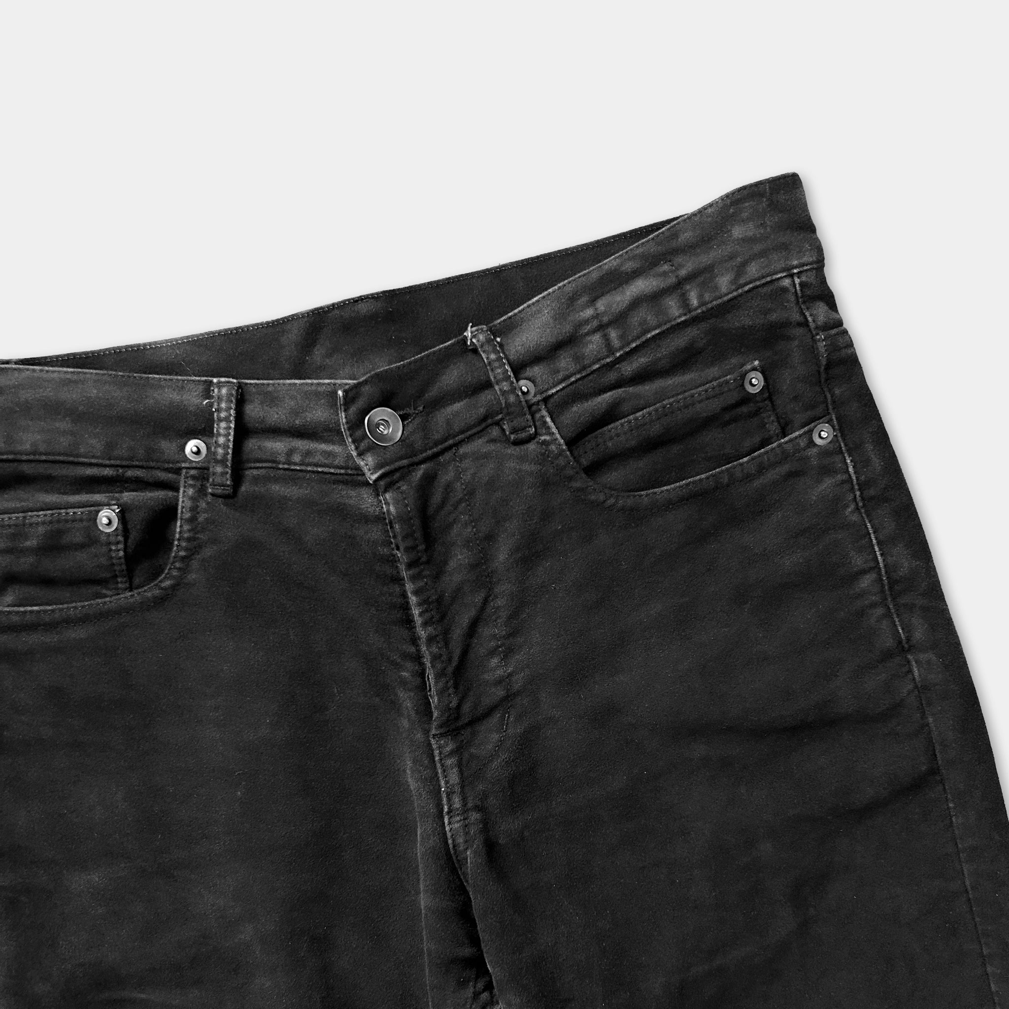 A pair of black jeans with a buttoned waistband and a pocket on the front.