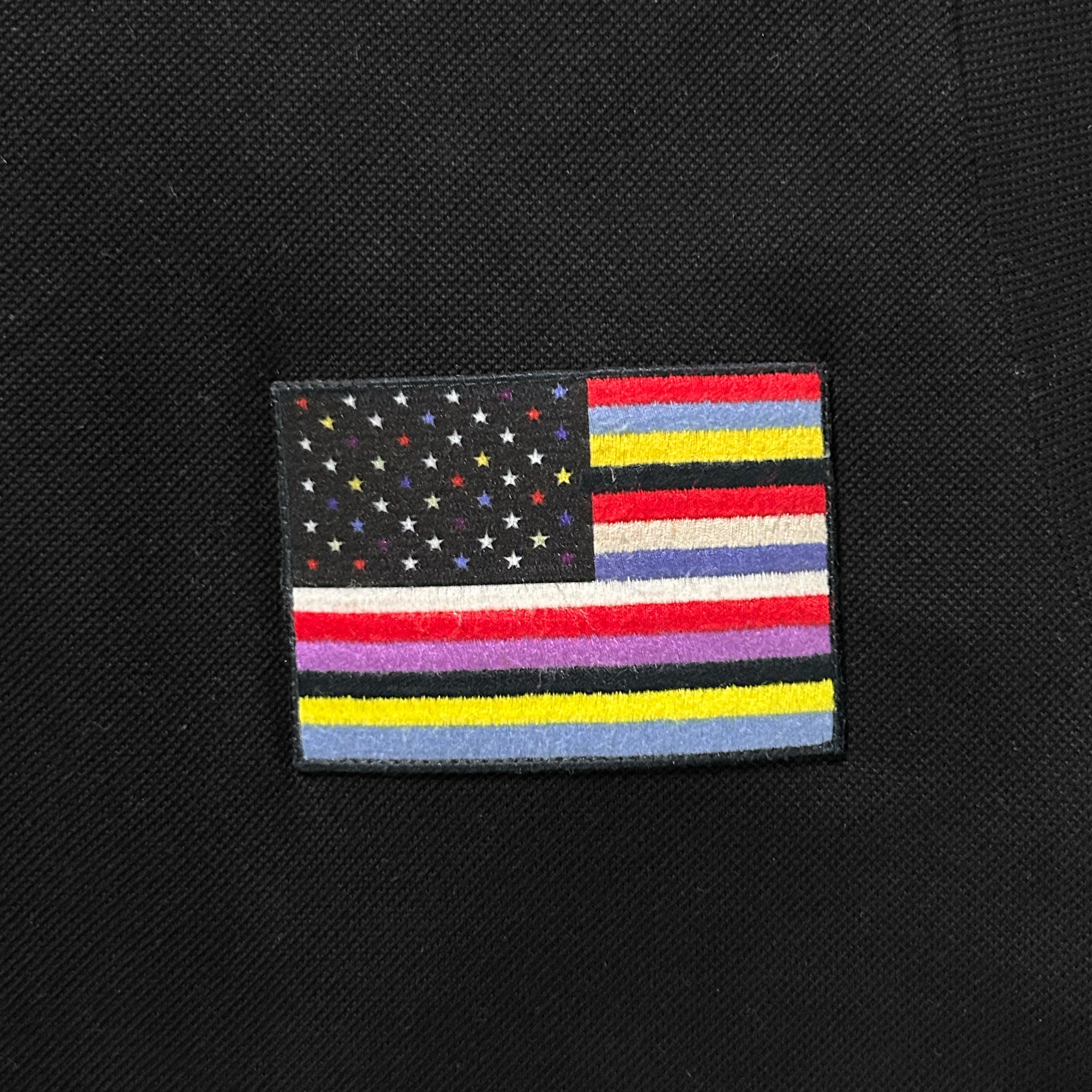 a patch with a colorful flag design on a black background.