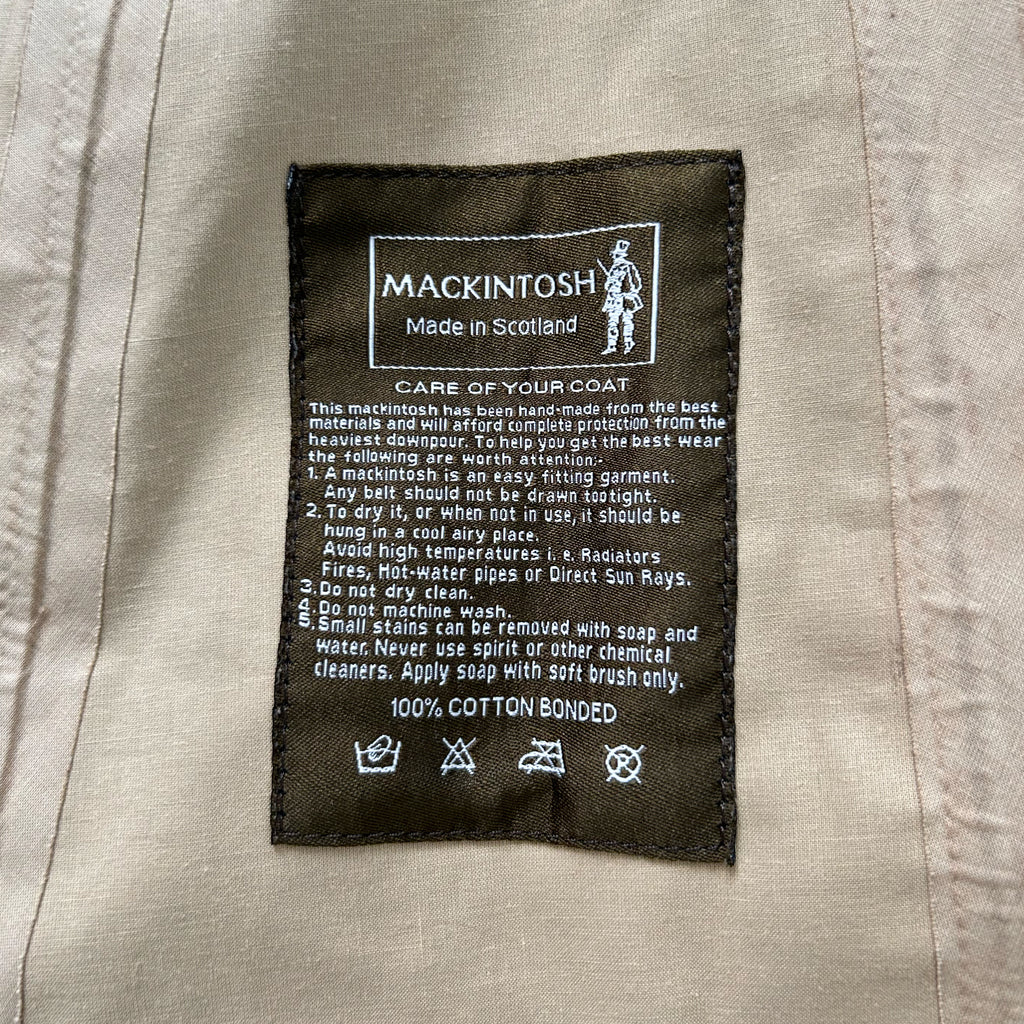 a close-up of a label on a piece of clothing, likely a coat, with text and symbols providing information about the product.