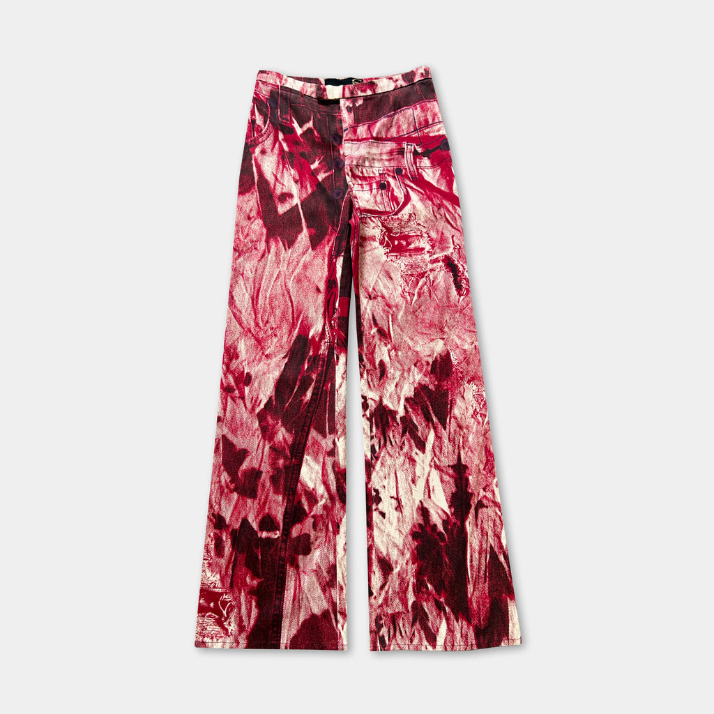 A pair of wide-leg pants with a bold, abstract red and white print pattern.