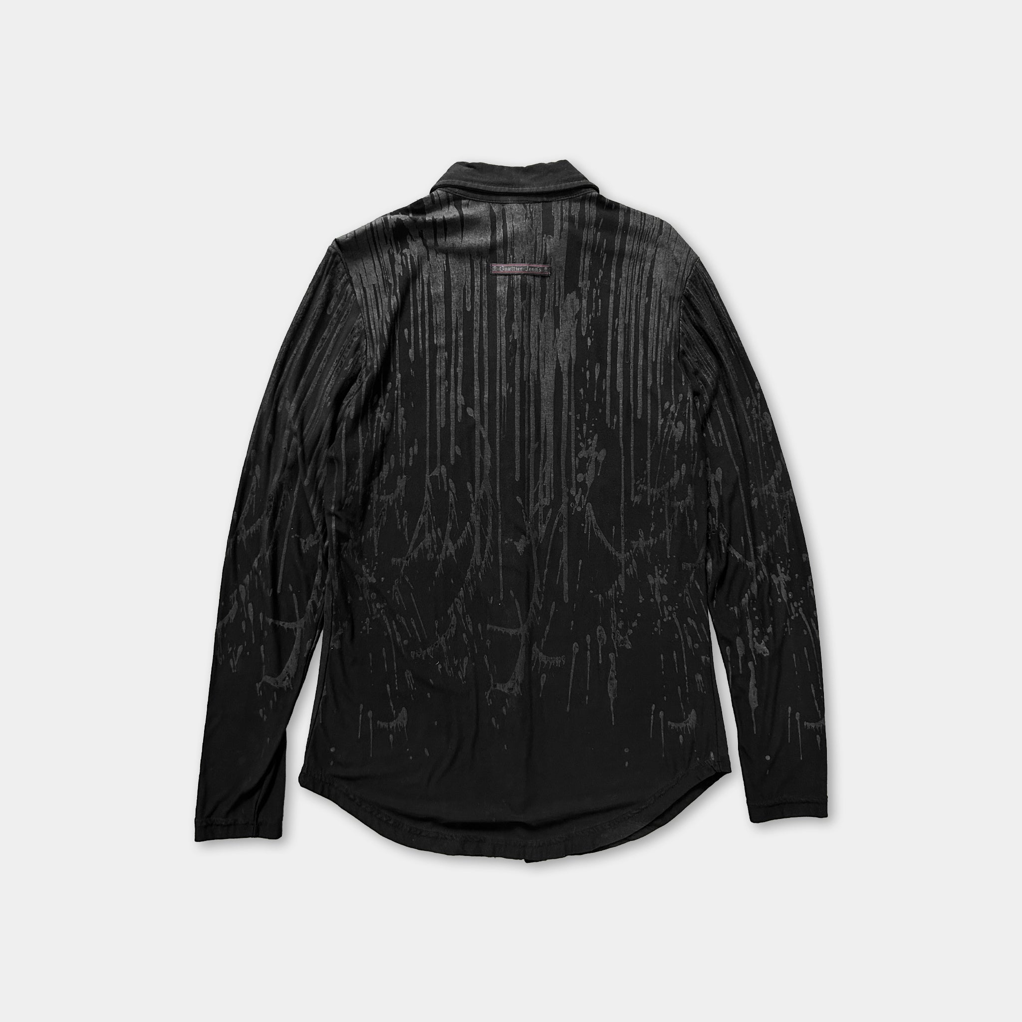 a black long-sleeved shirt with a unique, abstract pattern on the back.